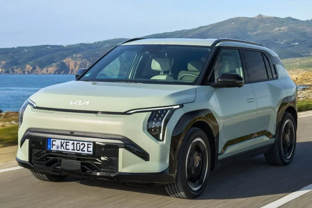 2027 Kia EV3 compact electric SUV shown from the front three-quarter angle on a city street