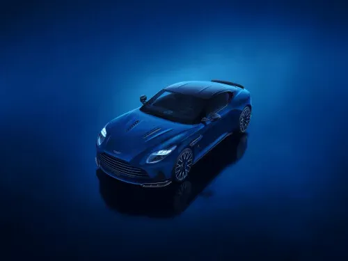 Aston-Martin-Sportwagen und SUV fahren in der Dämmerung gemeinsam auf einer kurvigen Straße