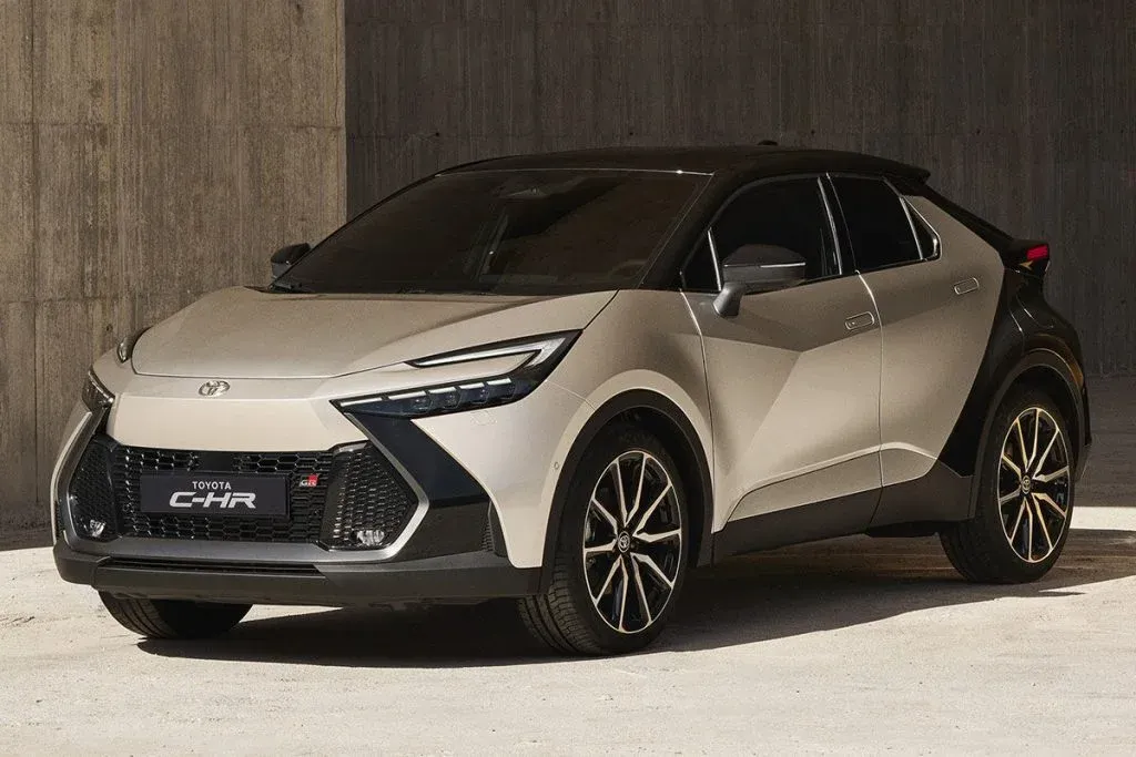 2026 Toyota C-HR electric compact SUV driving on a city street in daylight