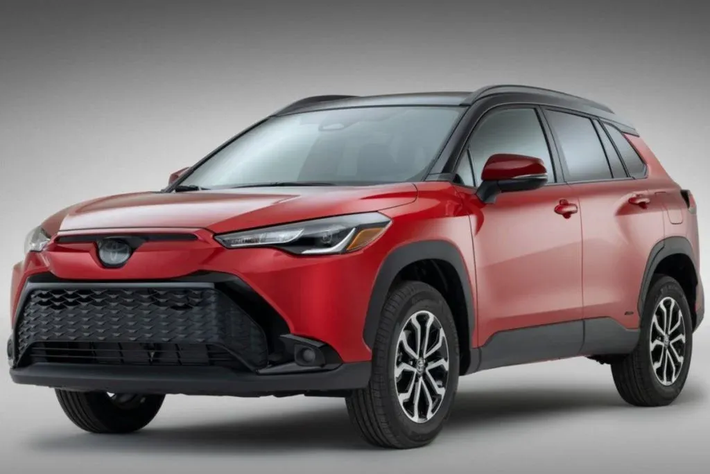Toyota Yaris Cross Hybrid und Lexus LBX auf einer Einfahrt, beide mit geschlossenen Türen und sichtbarem Markenemblem